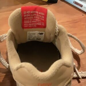 New Balance 574 tan, and orange kids sneakers